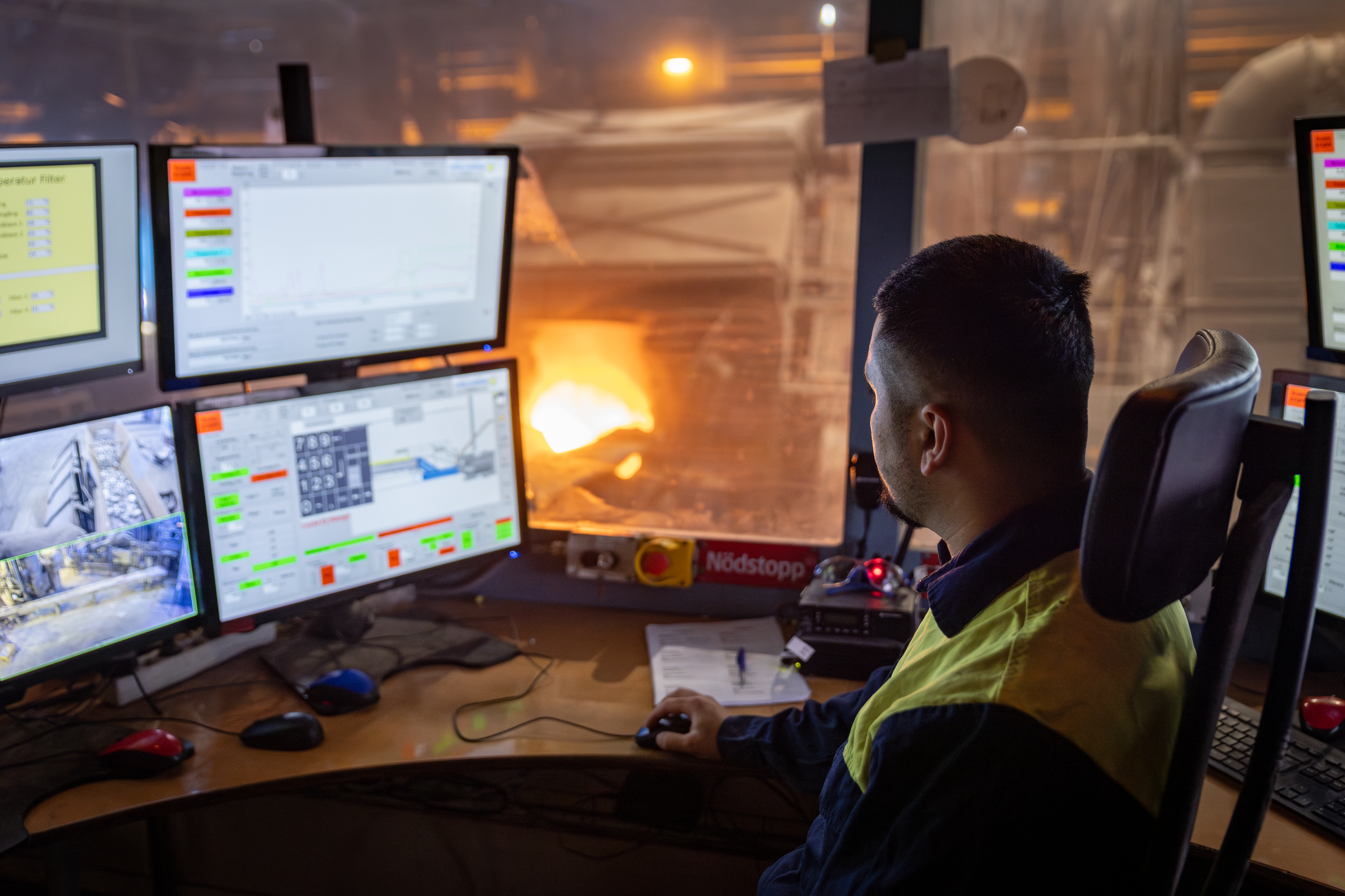 A Stena Aluminium employee overseeing production in a control room.